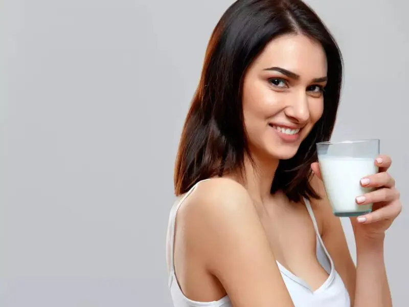 Beautiful woman drinking milk